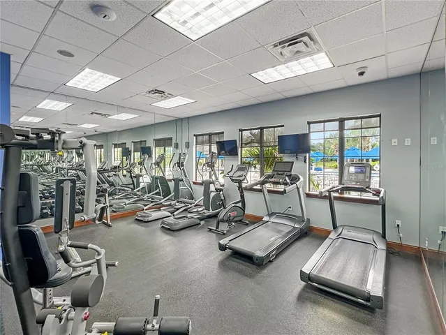 a room with gym equipment and a large window