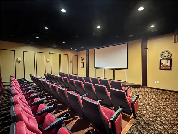 a media room with lots of chairs and a projector screen