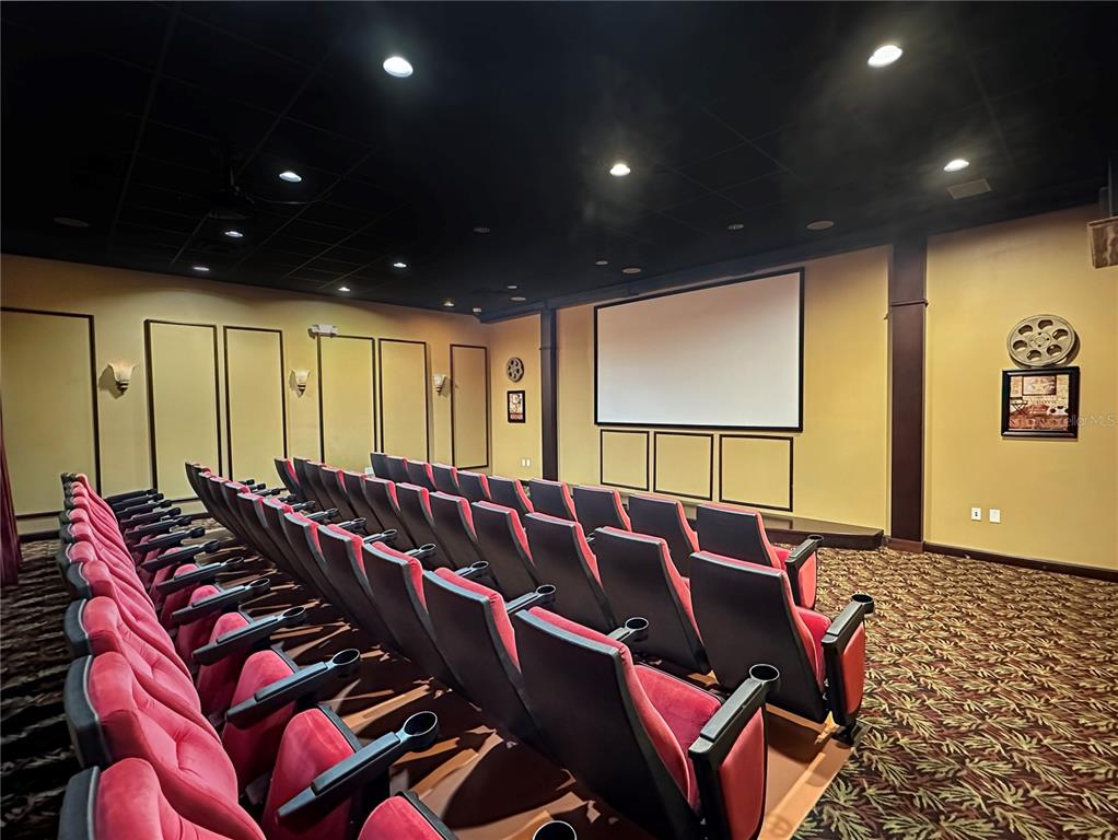 2942 Buccaneer Palm Road Kissimmee, FL 34747 - Photo 39 of 39 a media room with lots of chairs and a projector screen