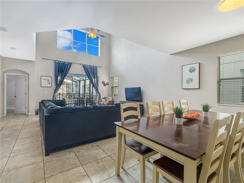 2942 Buccaneer Palm Road Kissimmee, FL 34747 - Photo 4 of 39 a living room with furniture and a wooden floor