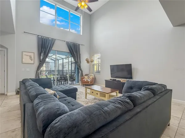 a living room with furniture a couch and a flat screen tv