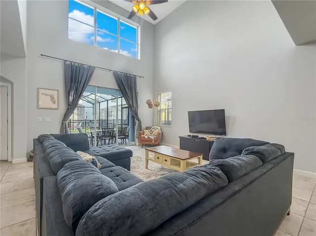 a living room with furniture a couch and a flat screen tv