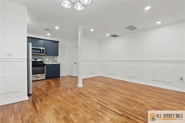 a view of kitchen with kitchen island a sink appliances and cabinets