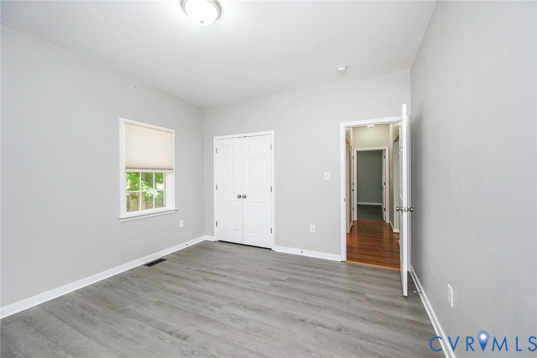 1297 Manfield Road Aylett, VA 23009 - Photo 27 of 41 an empty room with wooden floor and windows