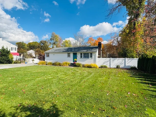 a view of a house with a backyard