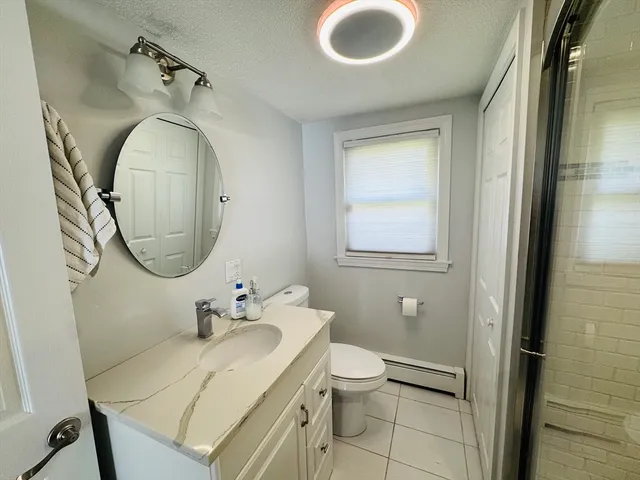 a bathroom with a toilet a sink and mirror