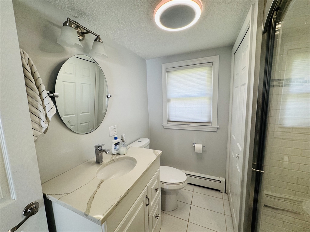 27 Fitchburg Street Marlborough, MA 01752 - Photo 12 of 37 a bathroom with a toilet a sink and mirror