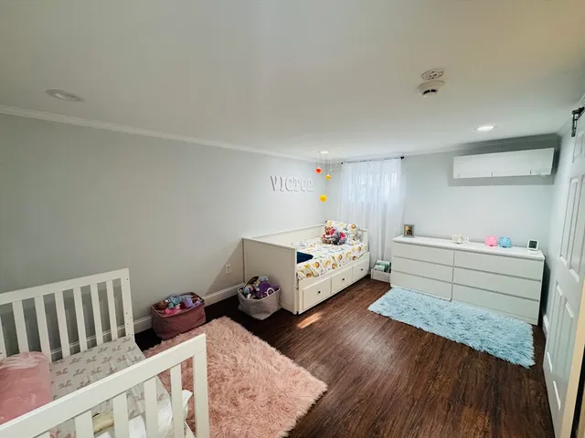 a bedroom with furniture and a wooden floor
