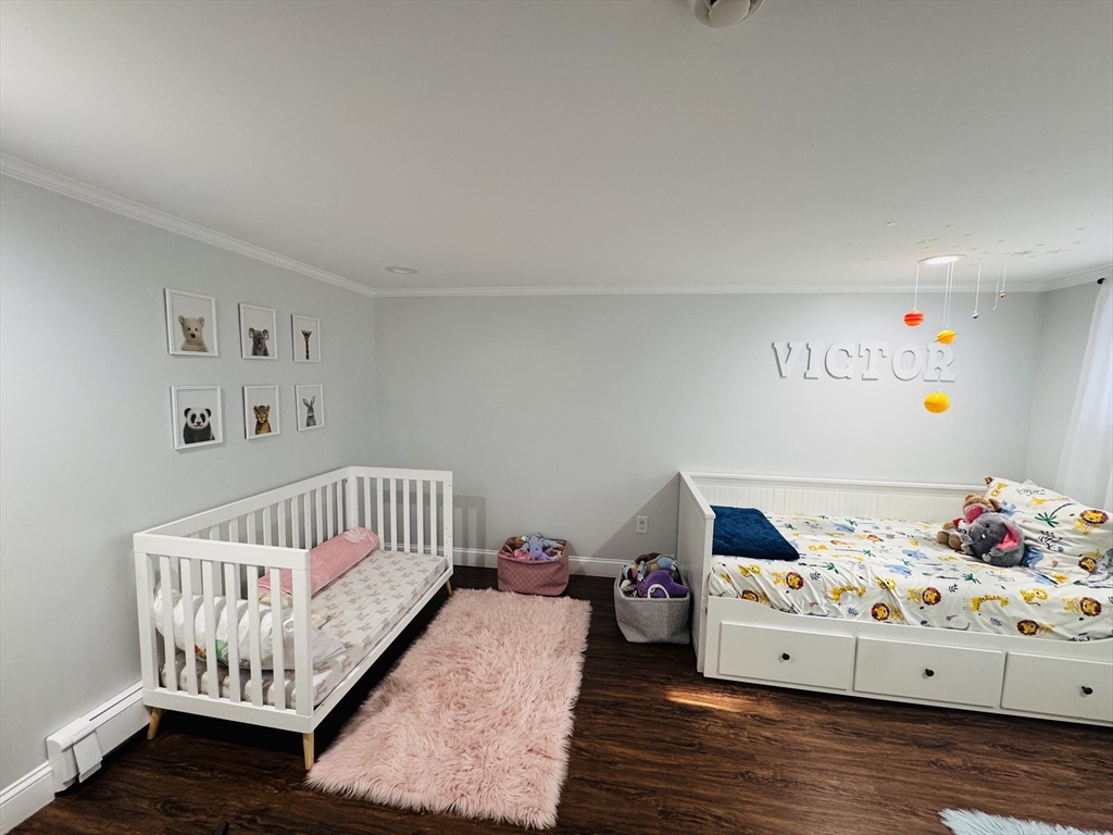 27 Fitchburg Street Marlborough, MA 01752 - Photo 27 of 37 a bed room with a bed and a baby crib