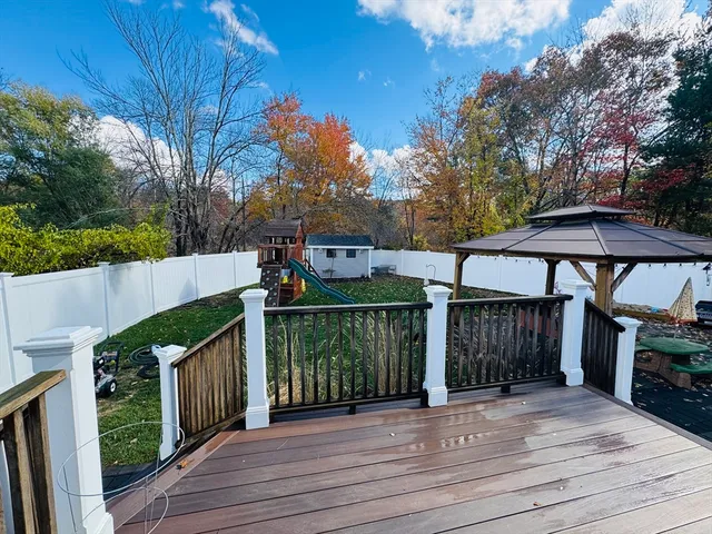 a view of a house with wooden fence