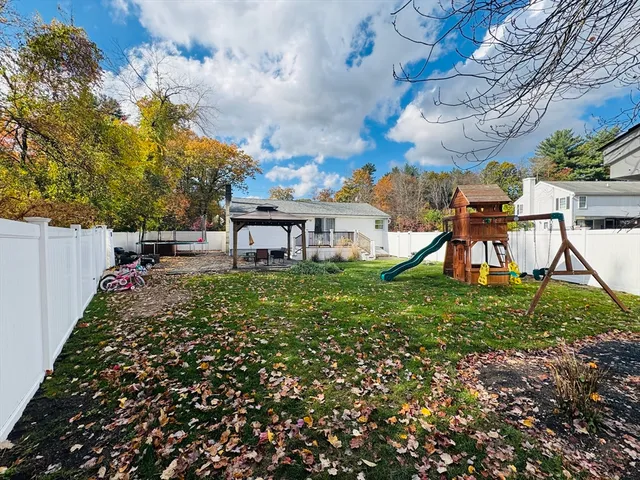 a view of a house with a backyard