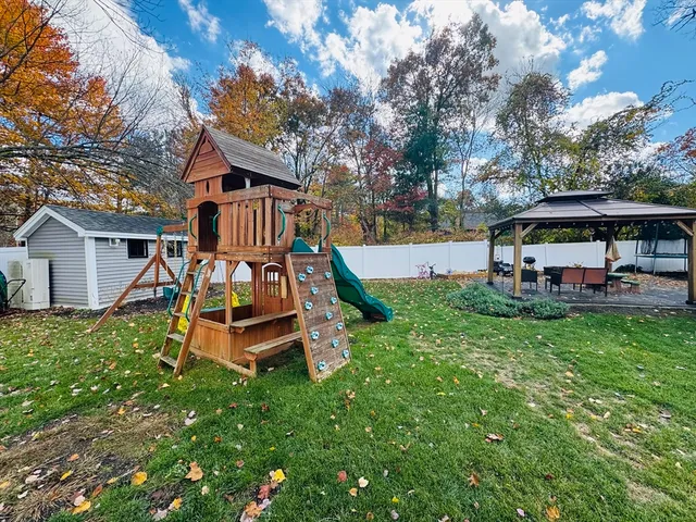 a view of a house with backyard and a slide