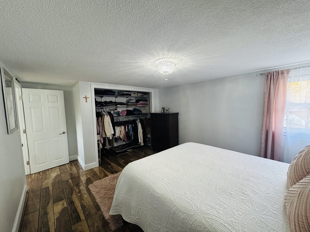 27 Fitchburg Street Marlborough, MA 01752 - Photo 8 of 37 a bed room with a bed and a book shelf