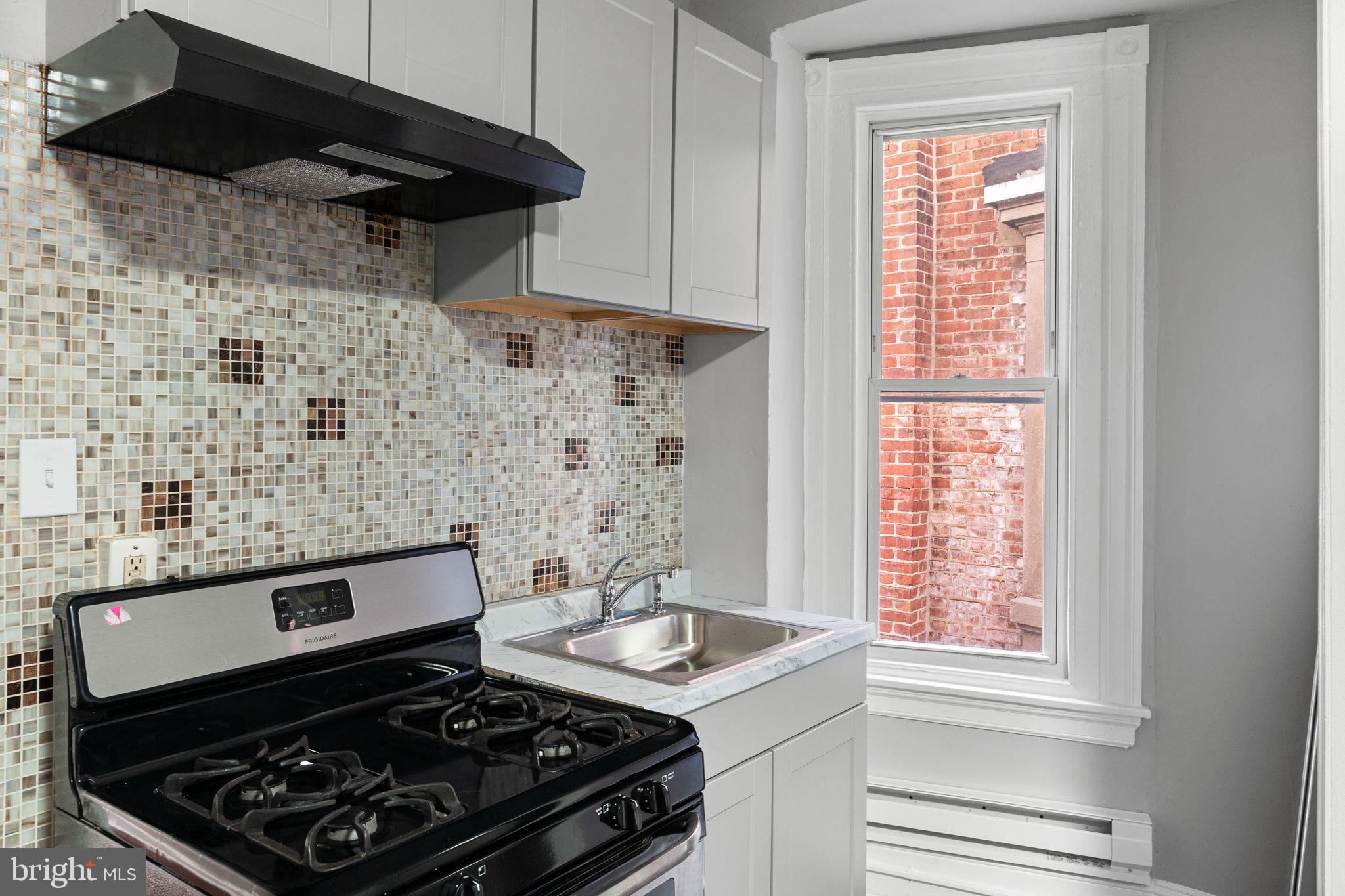 147 Manheim Street Philadelphia, PA 19144 - Photo 19 of 37 a stove top oven sitting inside of a kitchen