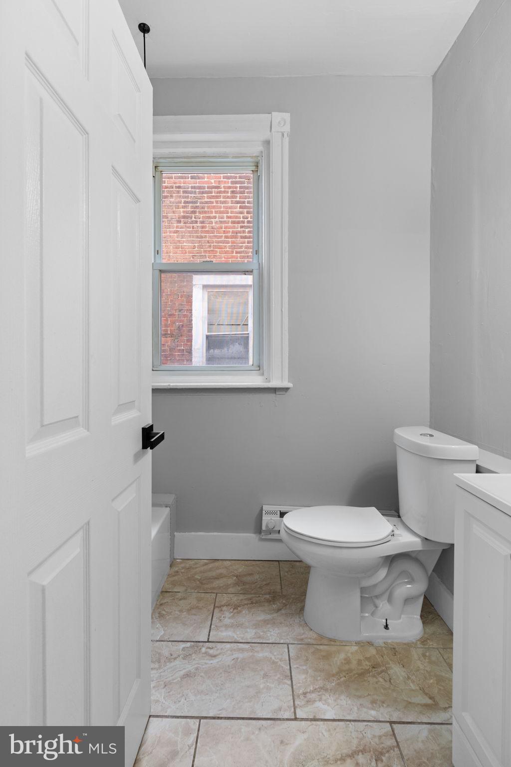 147 Manheim Street Philadelphia, PA 19144 - Photo 20 of 37 a bathroom with a toilet a sink and a window