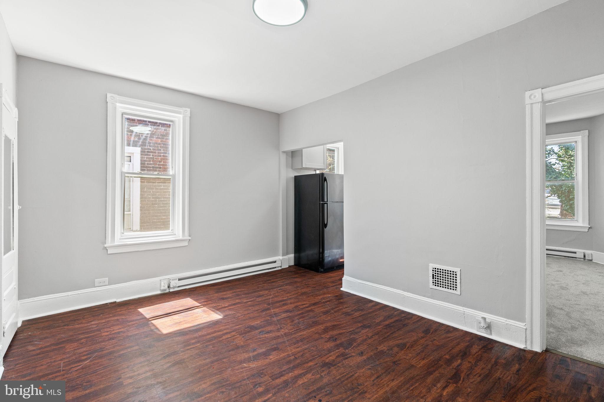 147 Manheim Street Philadelphia, PA 19144 - Photo 24 of 37 an empty room with wooden floor and windows