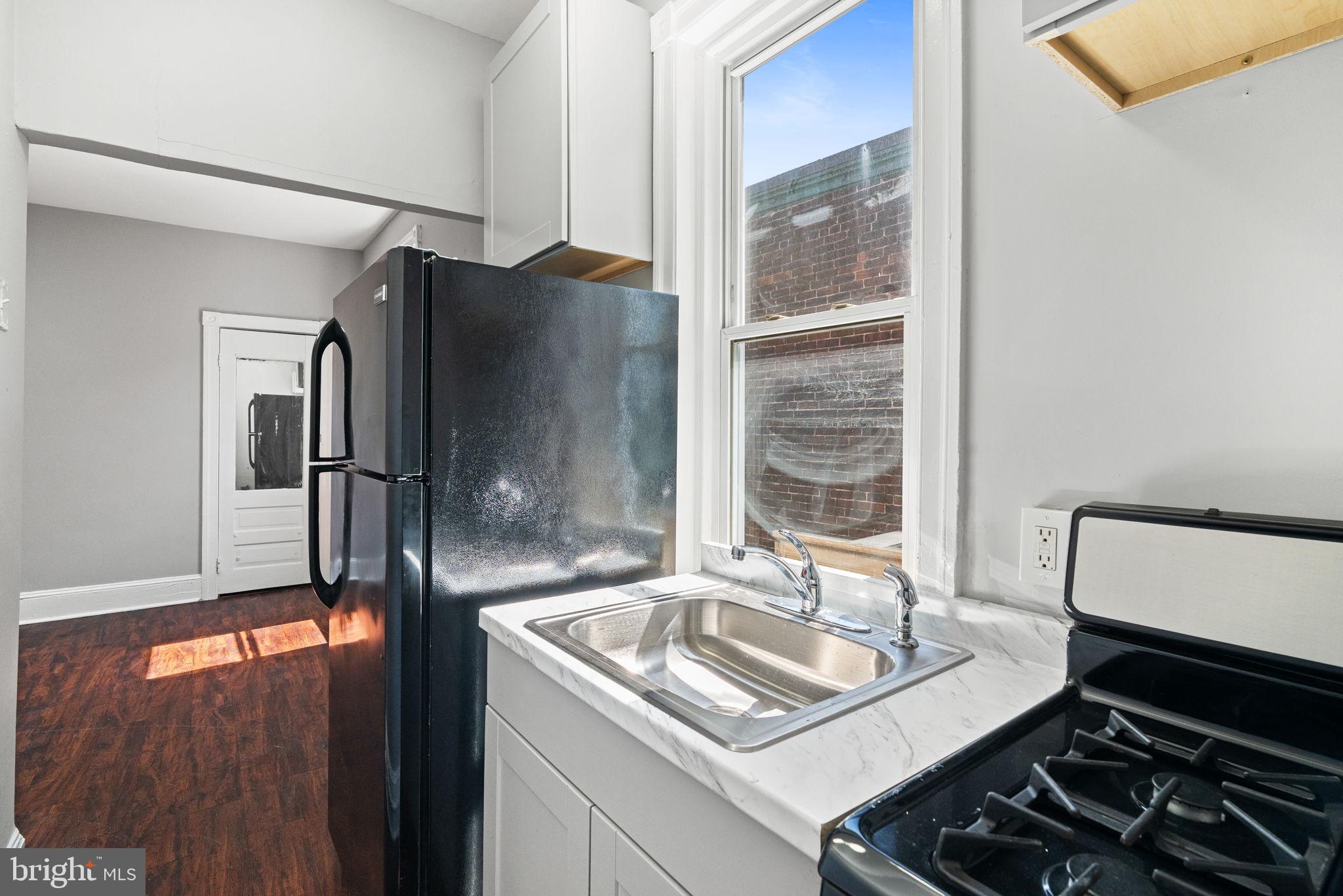 147 Manheim Street Philadelphia, PA 19144 - Photo 26 of 37 a kitchen with stainless steel appliances granite countertop a sink stove and refrigerator