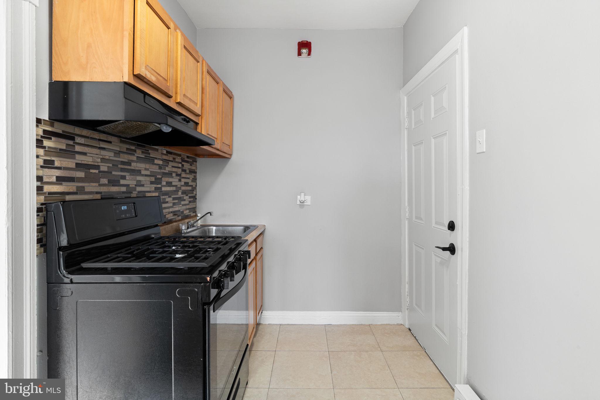 147 Manheim Street Philadelphia, PA 19144 - Photo 33 of 37 a kitchen with a stove and a microwave