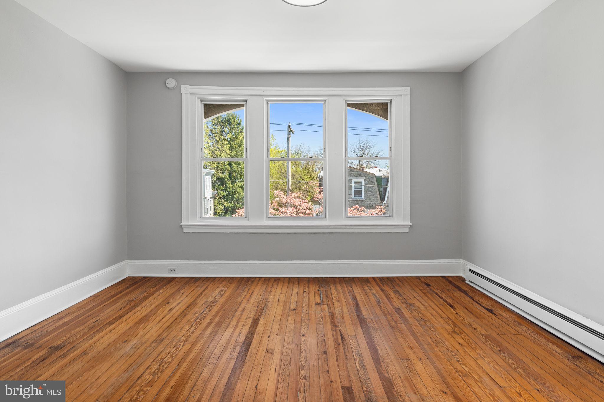 147 Manheim Street Philadelphia, PA 19144 - Photo 36 of 37 a view of an empty room with wooden floor and a window
