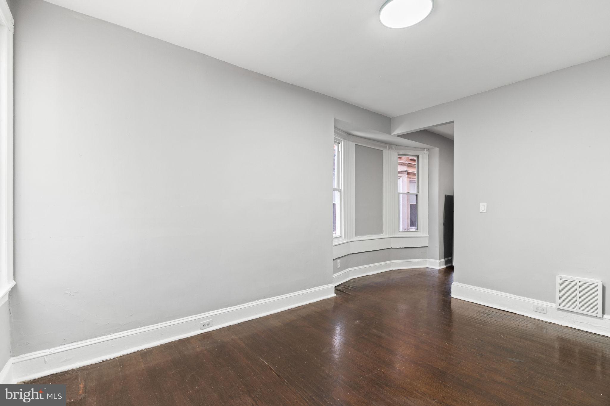 147 Manheim Street Philadelphia, PA 19144 - Photo 4 of 37 a view of an empty room with wooden floor and a window