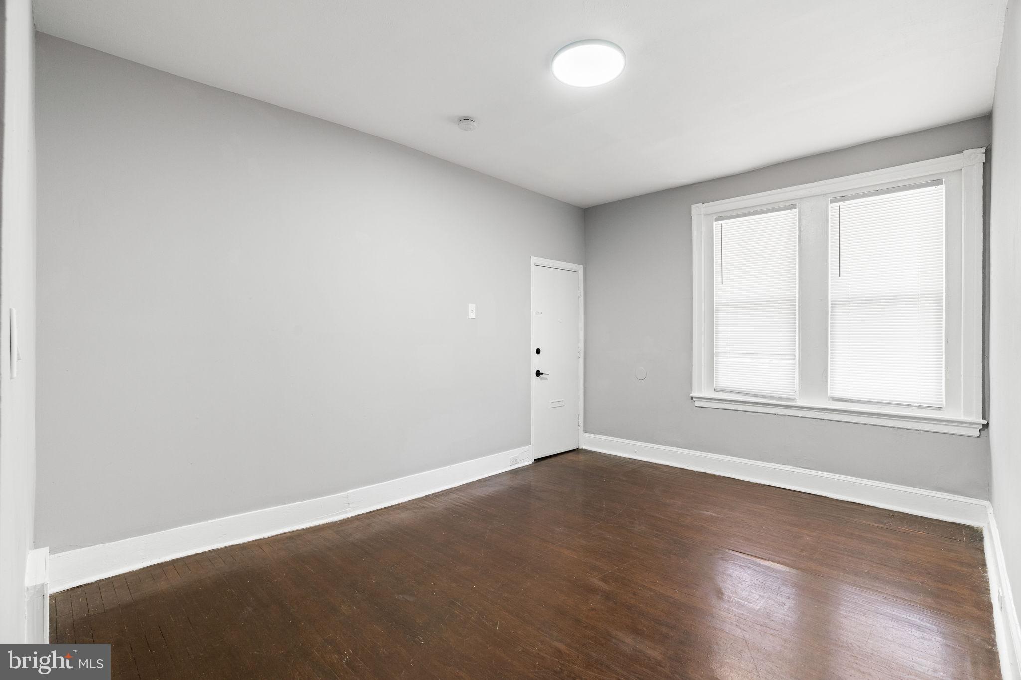 147 Manheim Street Philadelphia, PA 19144 - Photo 5 of 37 an empty room with wooden floor and windows