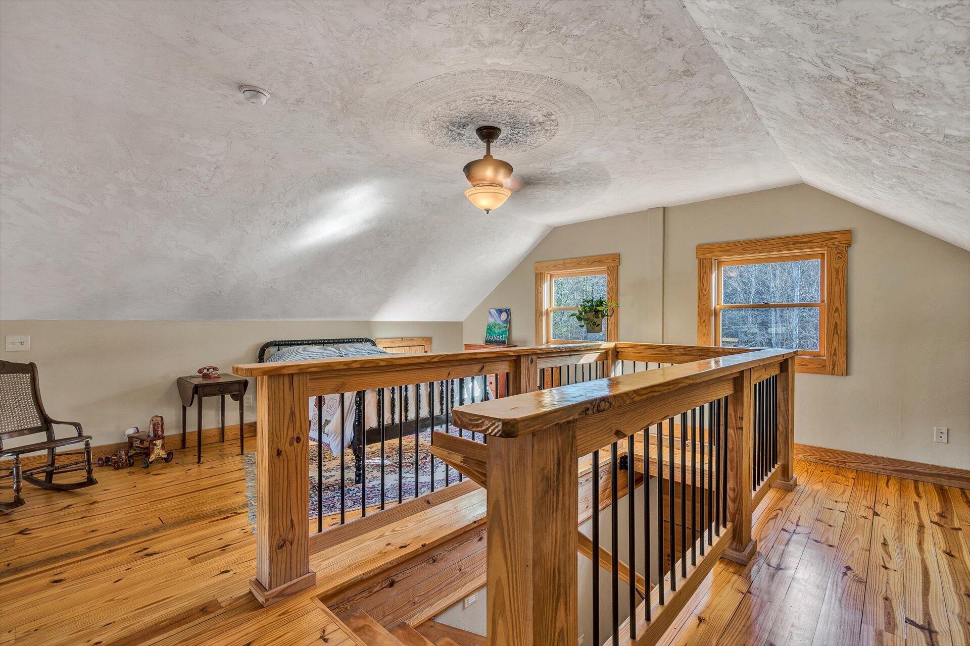 4076 Aerospace Road Roanoke, VA 24014 - Photo 31 of 62 a view of staircase with lots of frames on wall and wooden floor