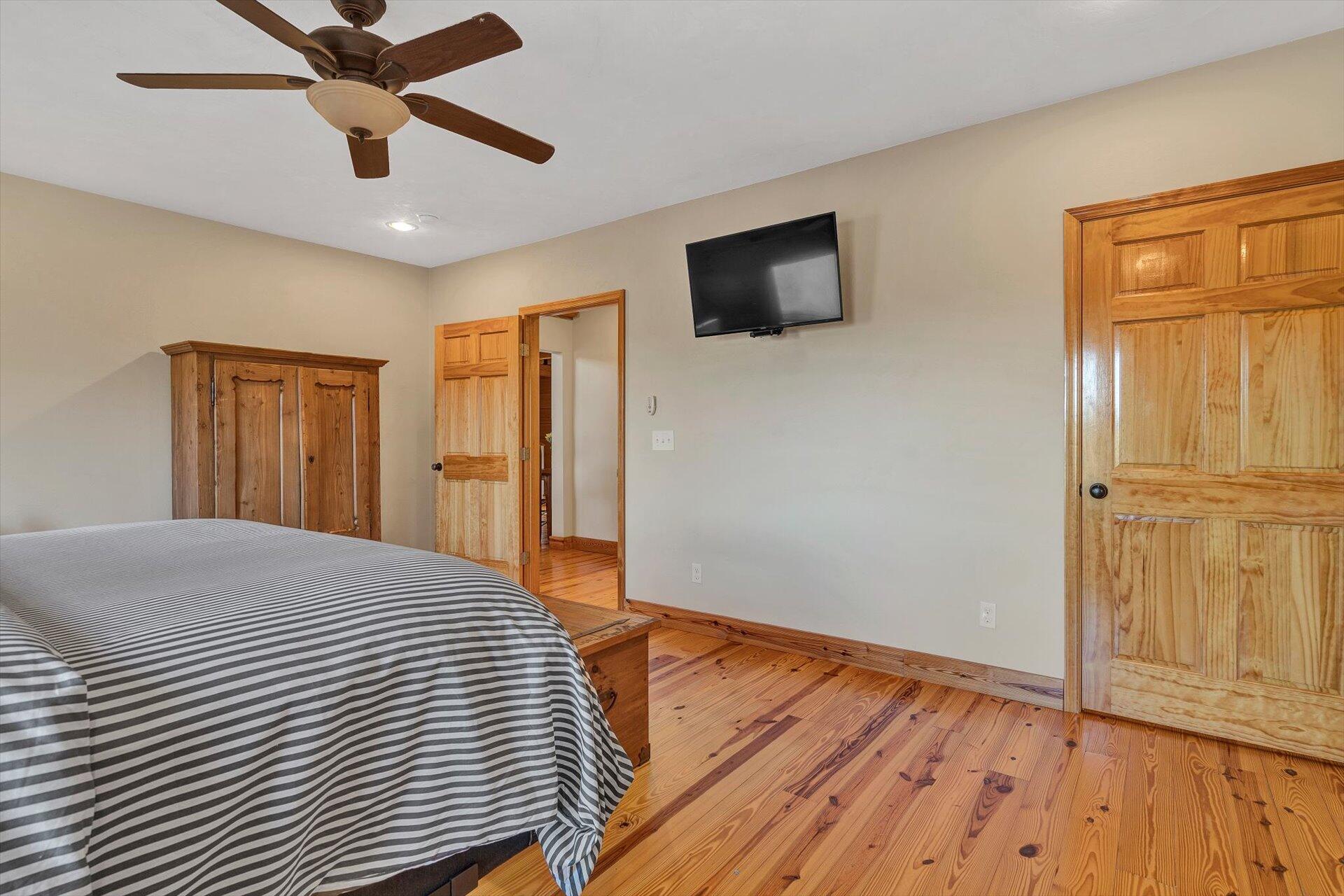 4076 Aerospace Road Roanoke, VA 24014 - Photo 36 of 62 a bedroom with a bed and wooden floor
