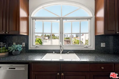 a kitchen with a sink and window