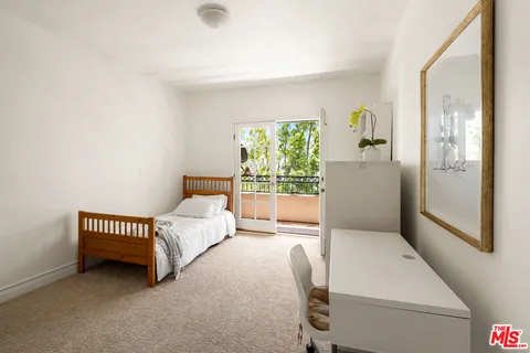 a bed room with a bed and a window