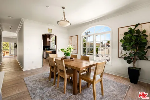 a view of a dining room with furniture and a potted plant