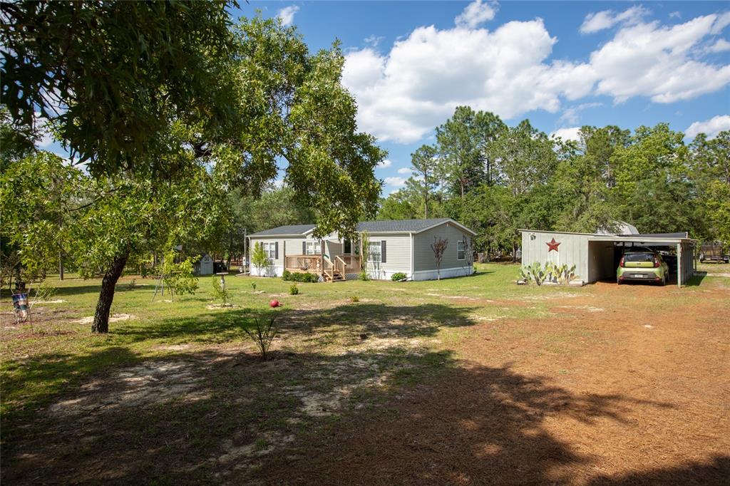 5670 Acadia Street Keystone Heights, FL 32656 - Photo 3 of 65 a front view of a house with a yard