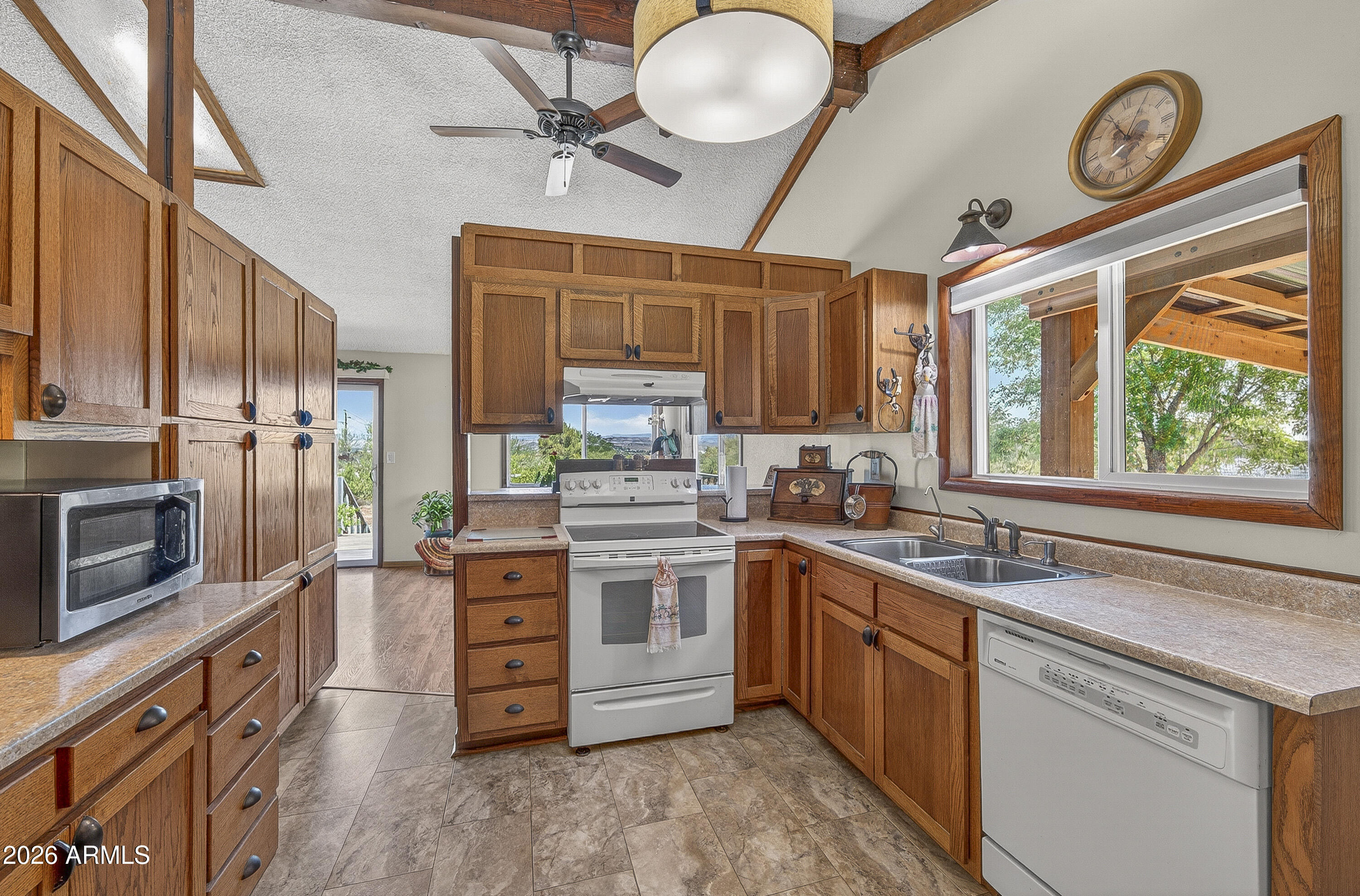 633 Oasis Road Camp Verde, AZ 86322 - Photo 44 of 50 a kitchen with stainless steel appliances granite countertop a stove and a sink