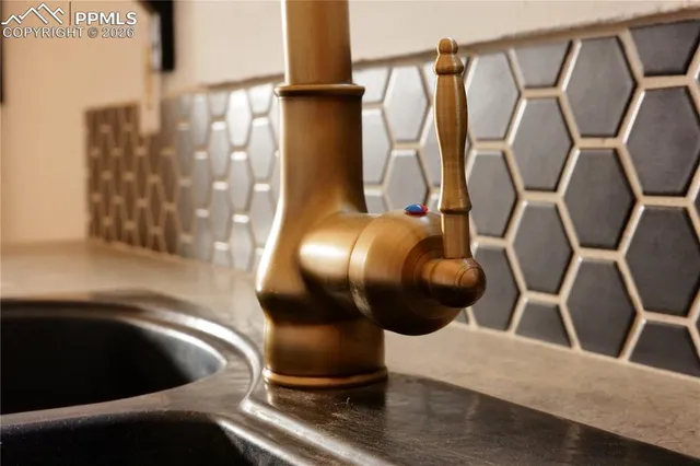 a kitchen with a stove a sink and a refrigerator