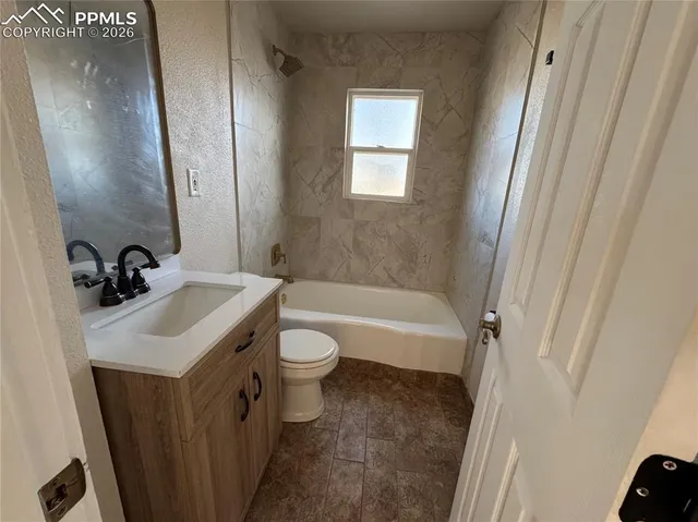 a view of a room with wooden floor and window