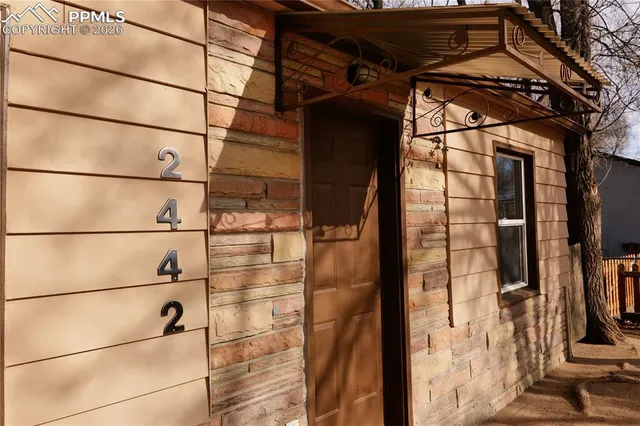 a view of a glass door with wooden floor
