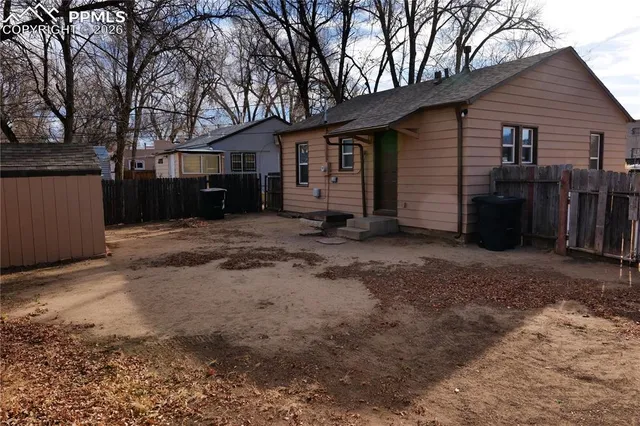 a view of a house with a yard covered in snow