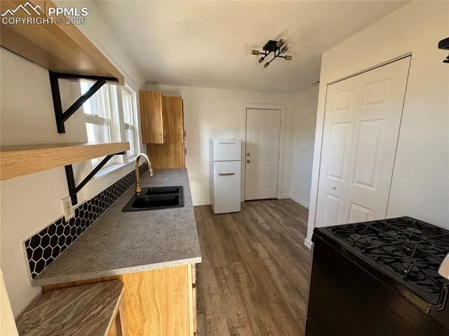 a kitchen with a refrigerator and a stove