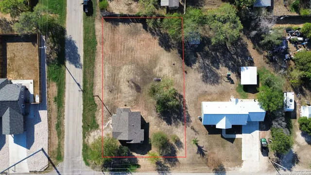 an aerial view of a house with a yard and potted plants