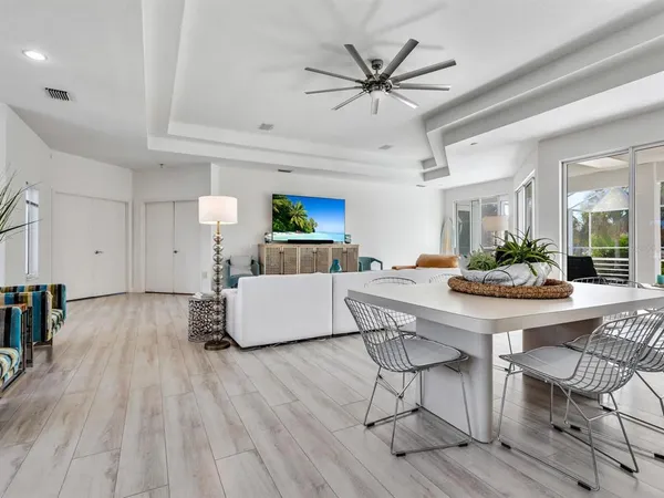a living room with furniture ceiling fan and a rug