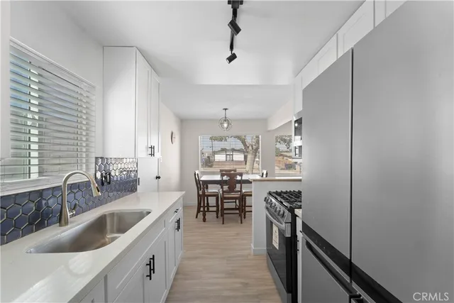 a kitchen with granite countertop lots of counter top space and stainless steel appliances