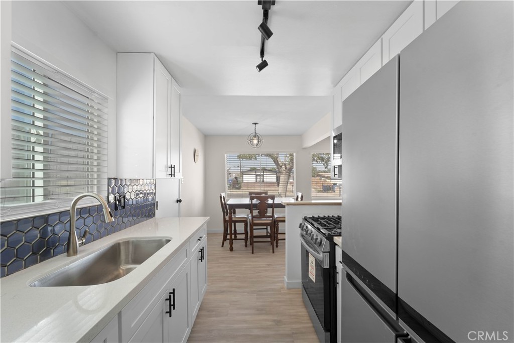 1836 Sunrise Road Barstow, CA 92311 - Photo 6 of 16 a kitchen with granite countertop lots of counter top space and stainless steel appliances