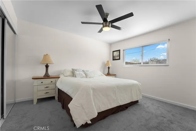 a spacious bedroom with a bed and a chandelier