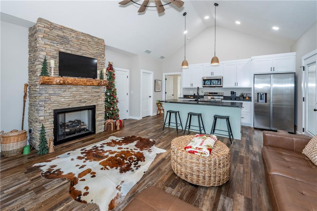 110 Burnt Mountain Cove Road Jasper, GA 30143 - Photo 12 of 33 a living room with stainless steel appliances kitchen island furniture and a fireplace