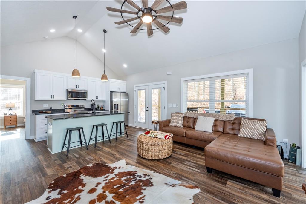 110 Burnt Mountain Cove Road Jasper, GA 30143 - Photo 13 of 33 a living room with furniture kitchen view and a wooden floor
