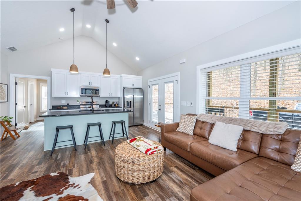 110 Burnt Mountain Cove Road Jasper, GA 30143 - Photo 14 of 33 a living room with kitchen island furniture and a large window