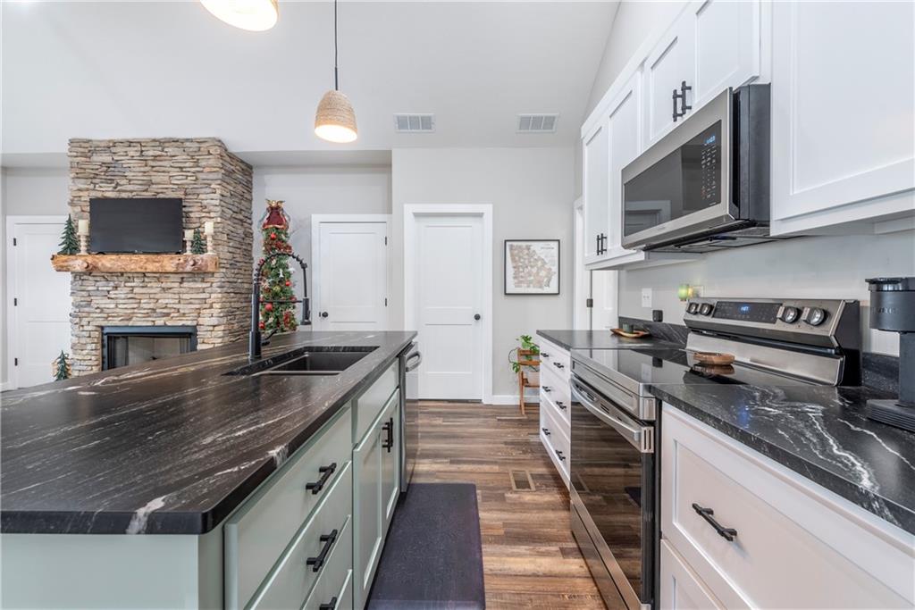 110 Burnt Mountain Cove Road Jasper, GA 30143 - Photo 17 of 33 a kitchen with stainless steel appliances granite countertop a stove and a microwave
