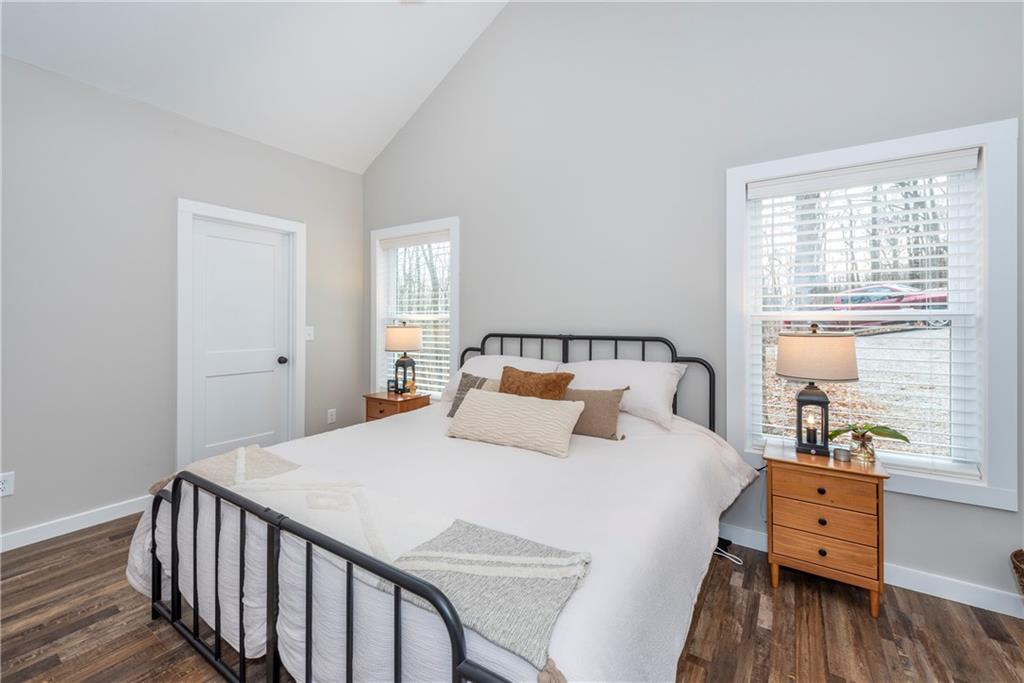 110 Burnt Mountain Cove Road Jasper, GA 30143 - Photo 25 of 33 a bedroom with a bed and wooden floor