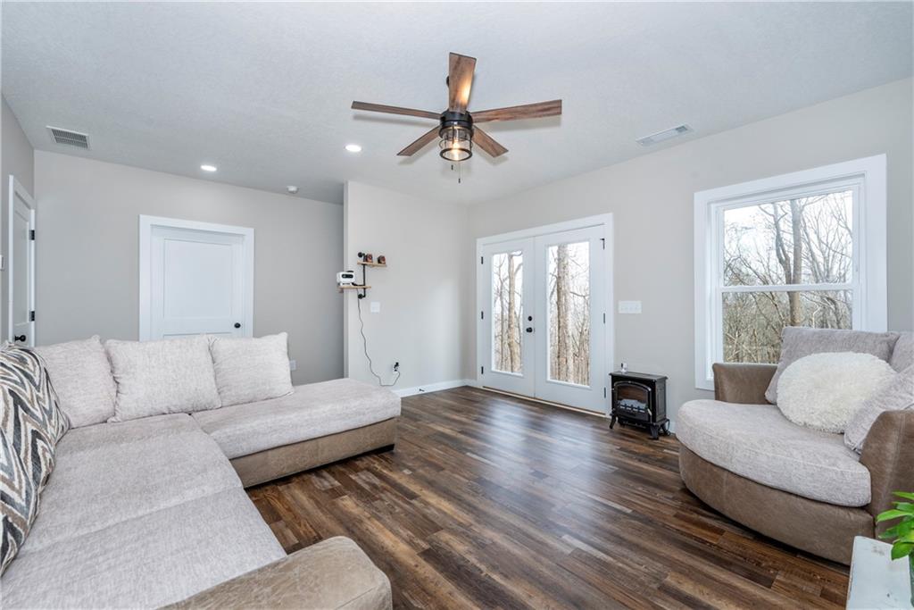 110 Burnt Mountain Cove Road Jasper, GA 30143 - Photo 30 of 33 a living room with furniture and a large window