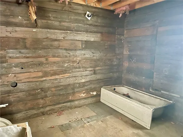 a bathroom with a bathtub and shower