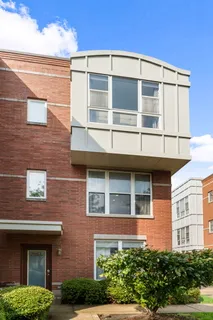 a view of a brick building next to a yard